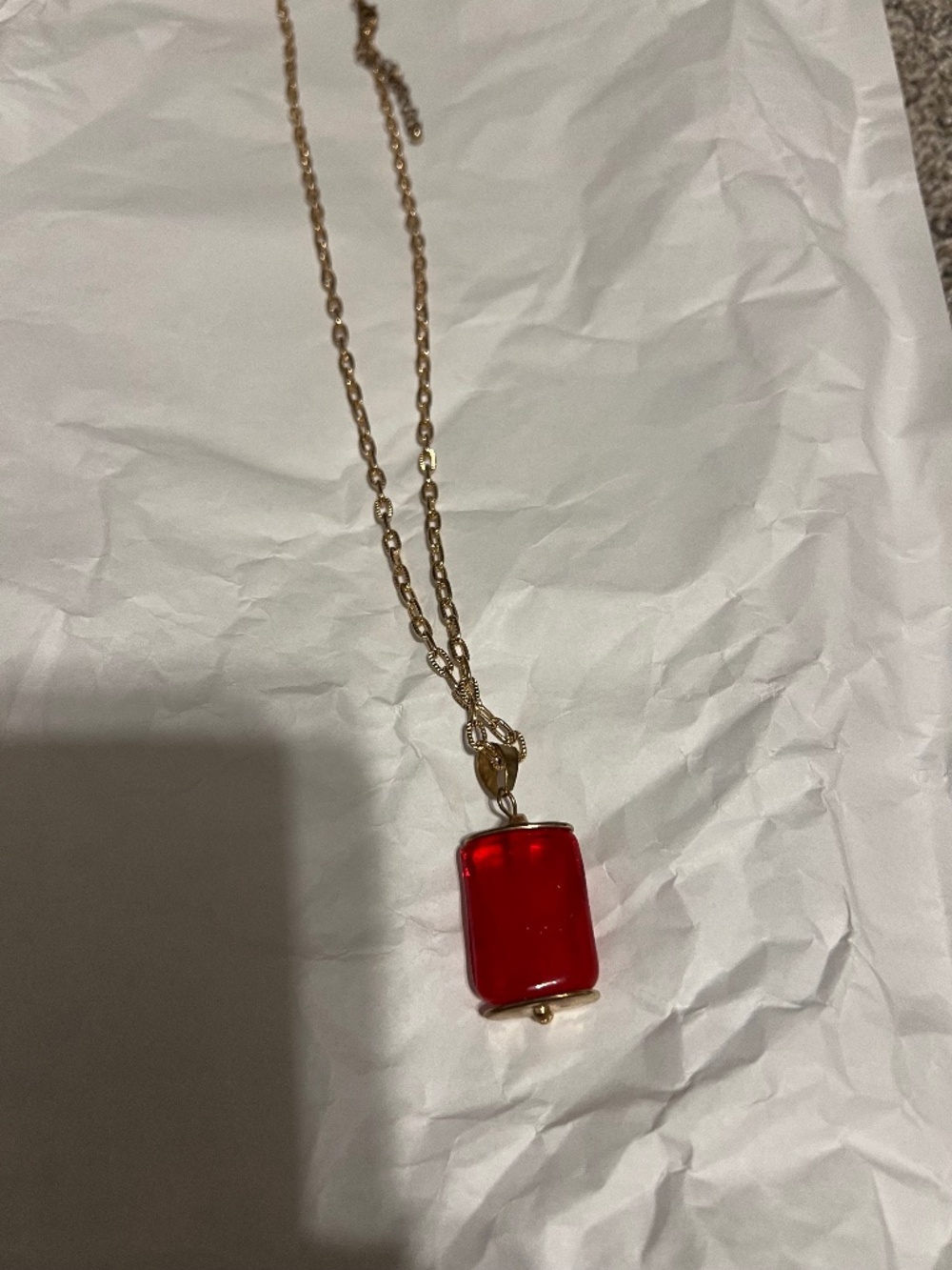 Gold necklace with red accent drop